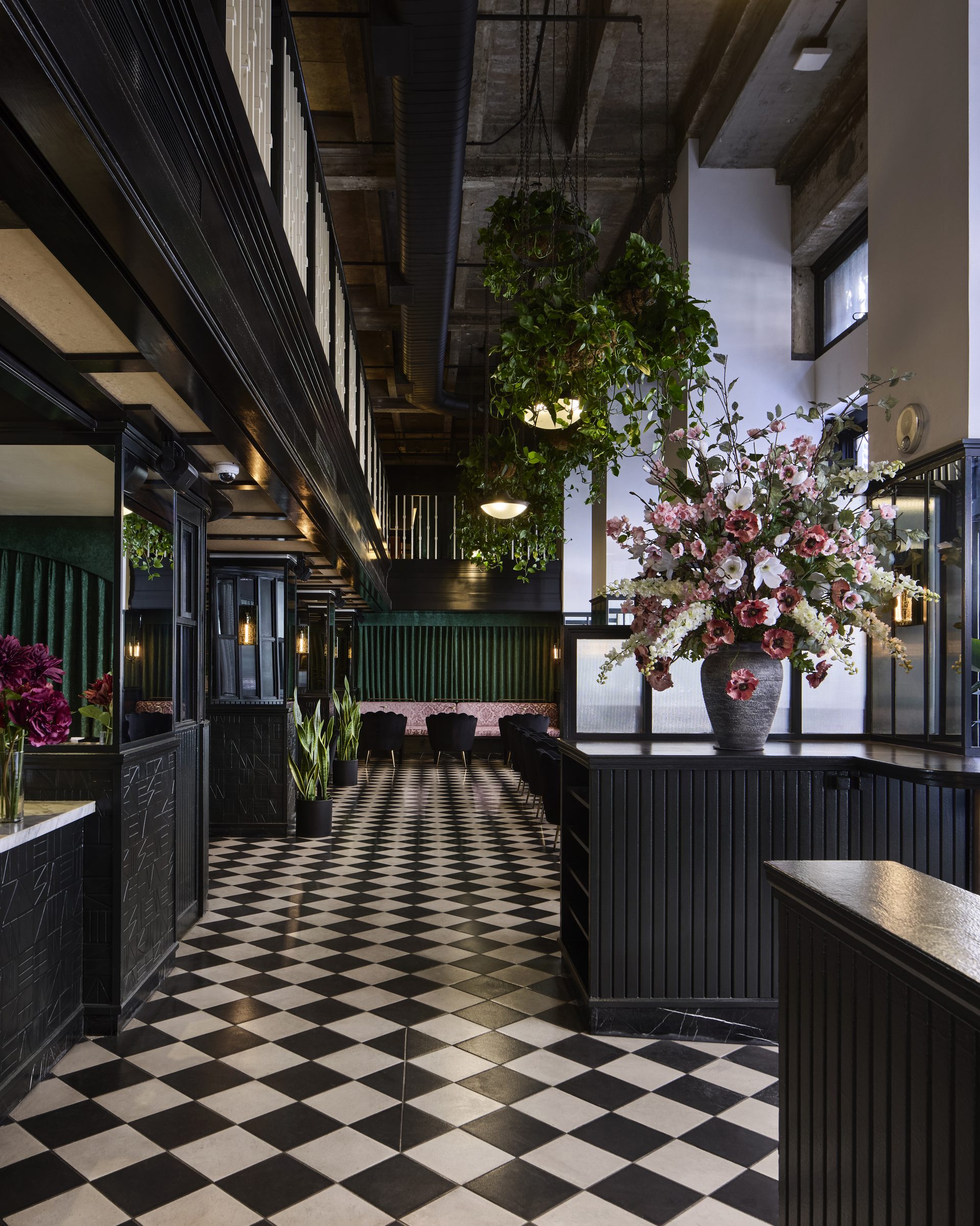 Inside Mary: black woodwork, green velvet, checkered floors, and fresh flowers in the historic United Artists building